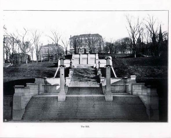 Early black-and-white of The Approach steps, looking eastward uphill toward Eighth Street, with the Main Building visible at top of steps.  Portion of the campus' original University Building visible at right (date unknown)