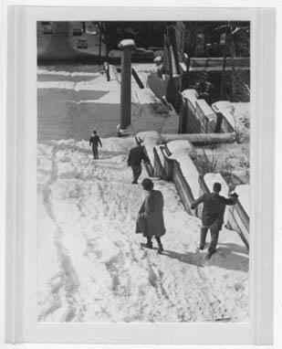 Photograph of students making their way down the snow-covered Approach steps (looking west-northwest downhill toward Troy, date unknown)