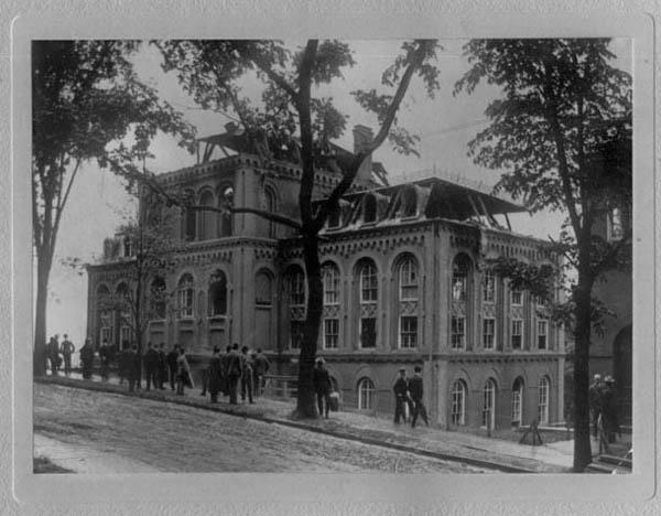 Photograph showing fire damage to Winslow Laboratory, including gutted top floors and broken windows (east-northeast elevation, circa 1904)