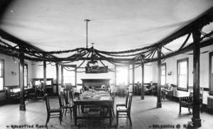 View of original Rensselaer Student Club House reading room featuring large central table, reading chairs and fireplace (circa early 1900s)