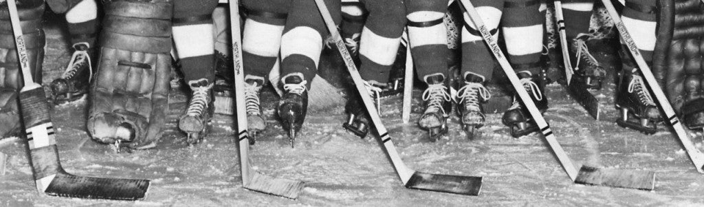 RPI hockey players holding Northland Pro hockey sticks in a team photo in the 1957 Transit.