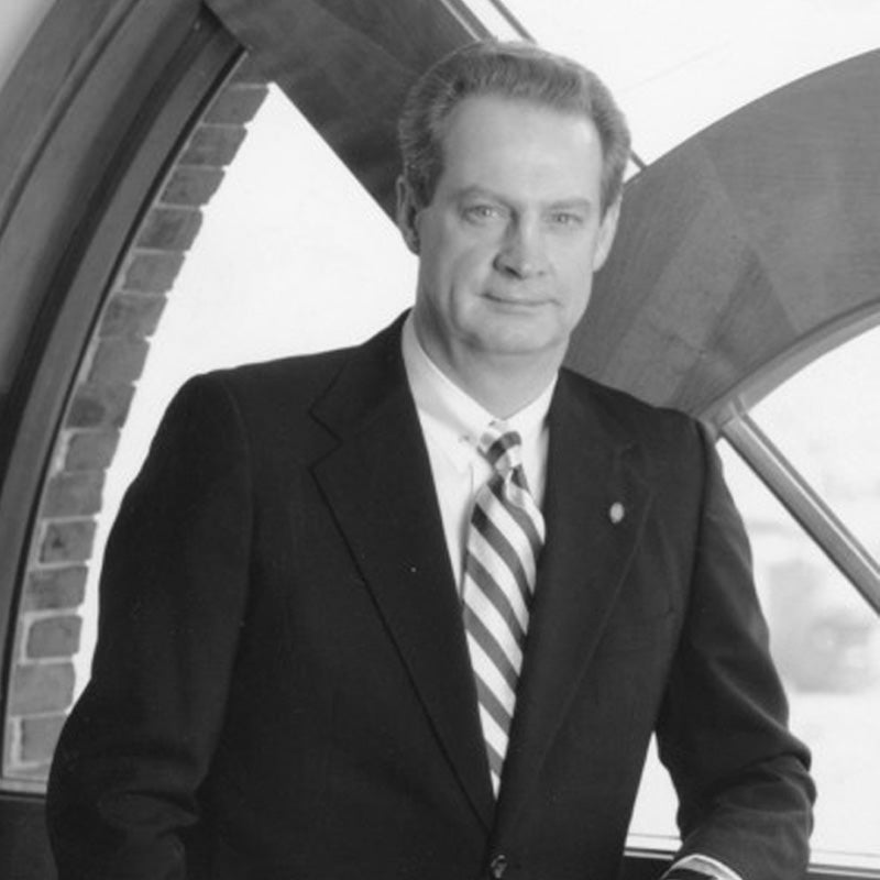 Black-and-white mid-range photograph of R. Byron Pipes, standing in front of a window