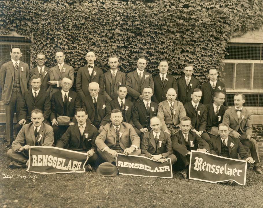 Outdoor photo of some members of the Class of 1913 holding 'Rennselaer' banners at the 1923 (10 year) reunion