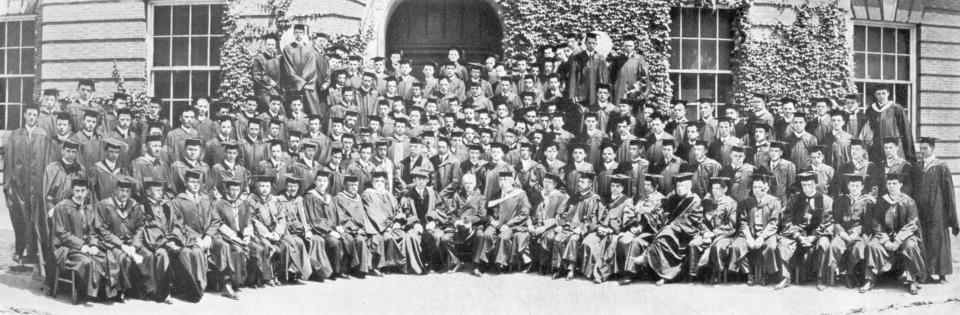 Photo showing the graduating Class of 1913 in caps and gowns