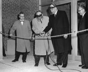 Photograph taken of local dignitaries using a blowtorch to cut a chain at the Science Center's dedication(October 21, 1961)