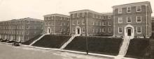 Exterior view of E-dormitories, with North Hall beyond, as seen from Sage Avenue (southeast elevation, date unknown)