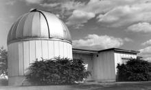 Exterior view of original observatory, with facility's large dome in foreground