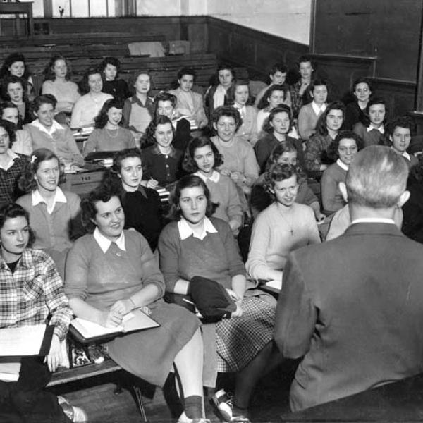 View of women in the Curtiss-Wright program seated in a lecture hall with the instructor's back to the camera.